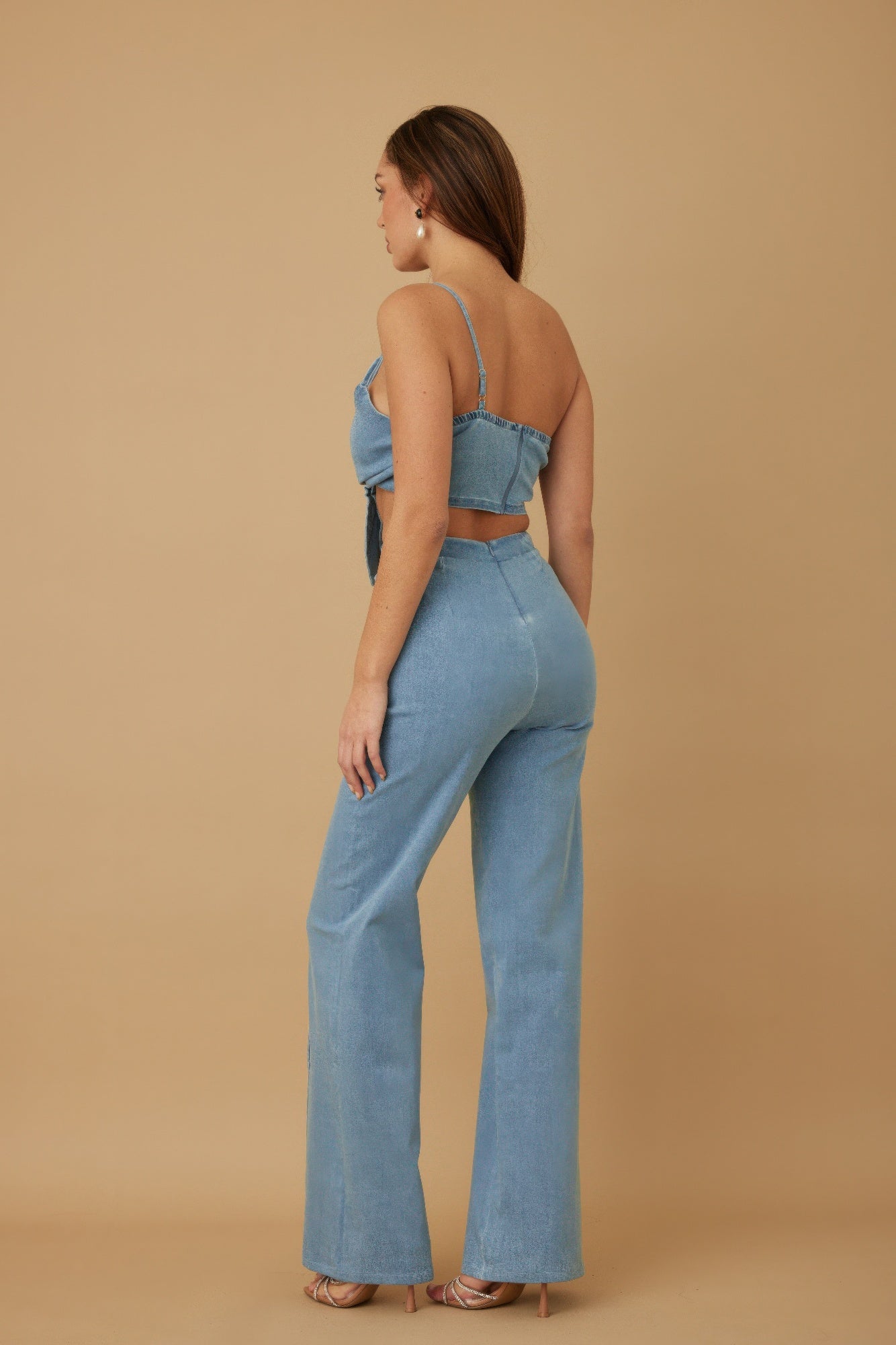 Side view of light denim blue wrap flower crop top and wide-leg pants