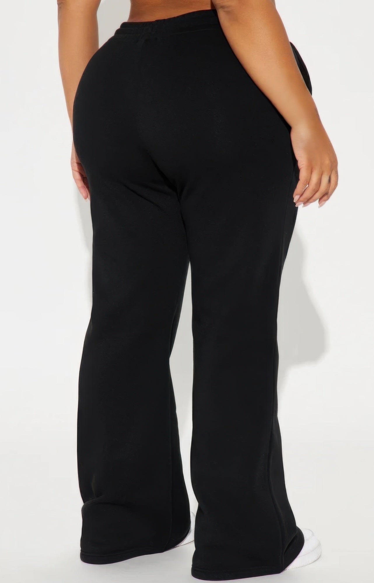 Black flared lounge pants, back view with wide straight-to-bell legs