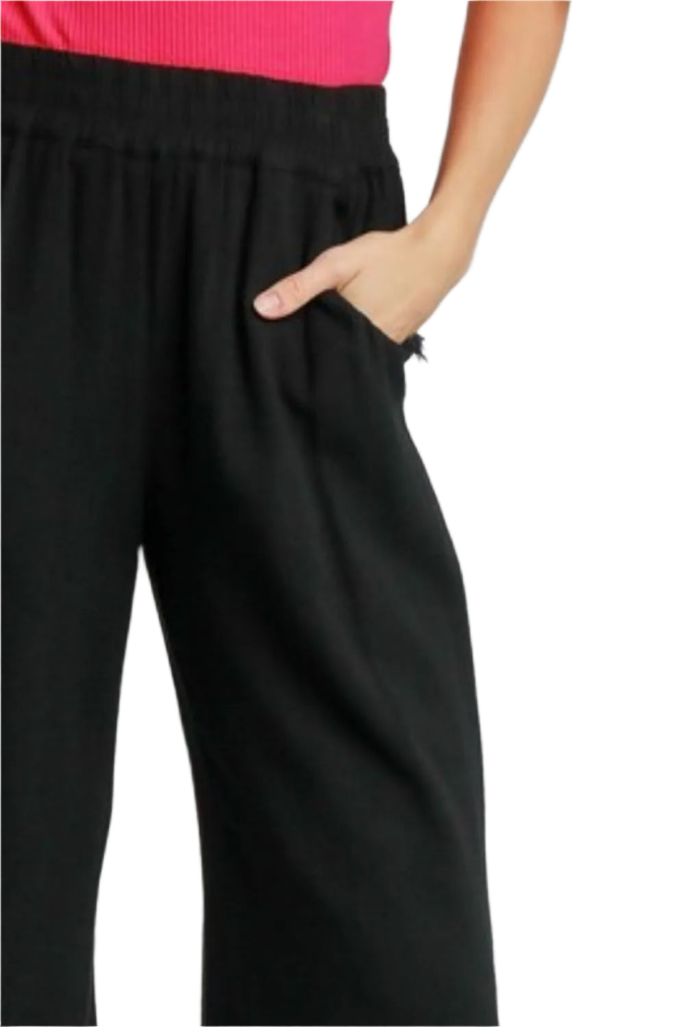 Close-up: black elastic-waist wide-leg pants with soft drape and frayed hem