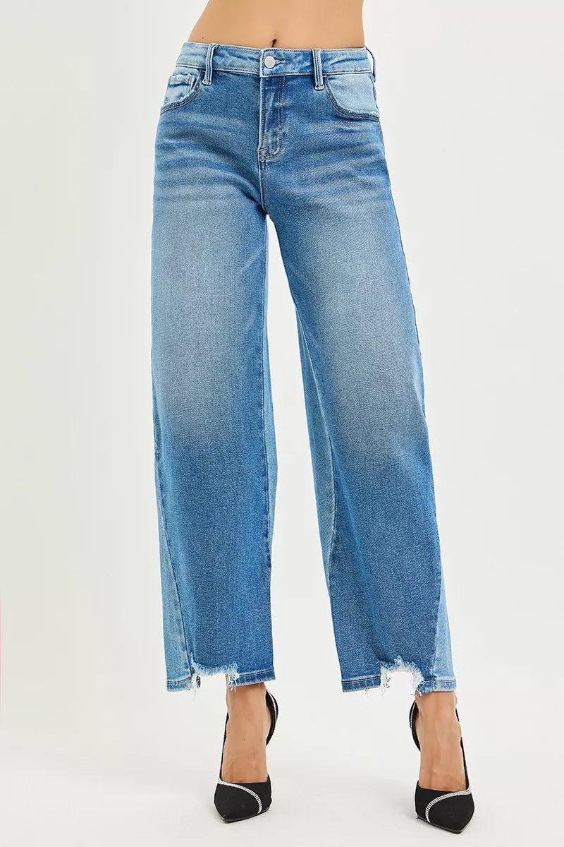 Front view of washed blue wide-leg jeans with button waist and frayed ankle hem