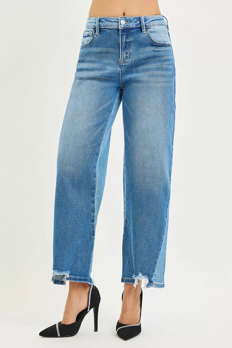 Washed blue cropped barrel jeans with zip fly, belt loops, and frayed bottom edges
