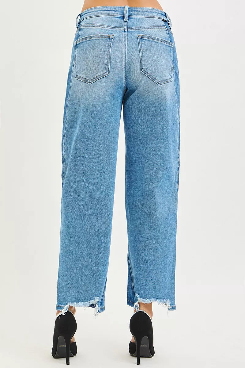 Back view: light blue wash barrel jeans with two rear pockets and frayed hem edge