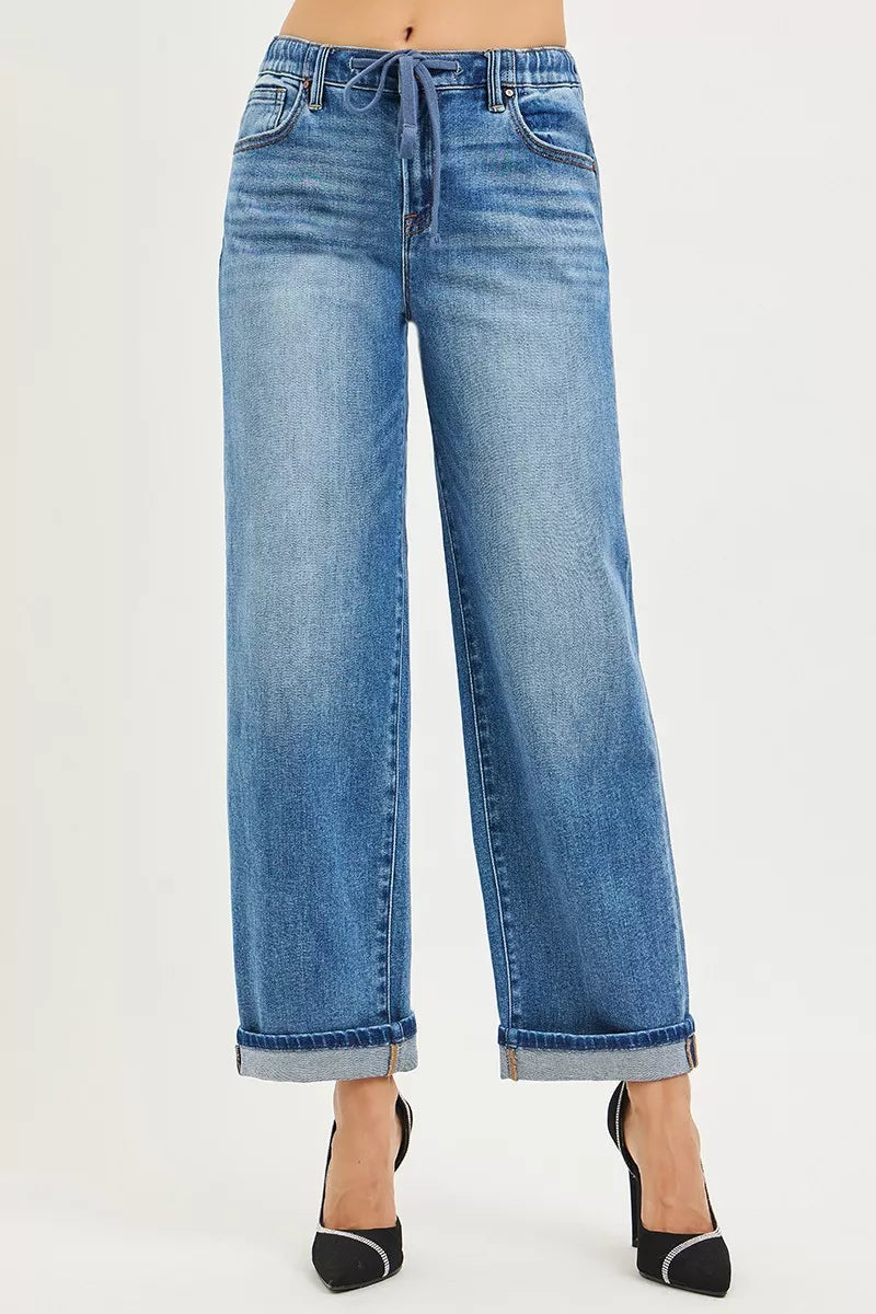Front close-up blue slouch jeans with drawstring waist and rolled cuff hem