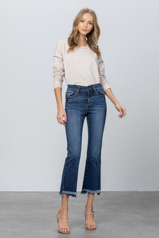 Dark blue bootcut crop jeans with frayed raw hem and distressed waistband