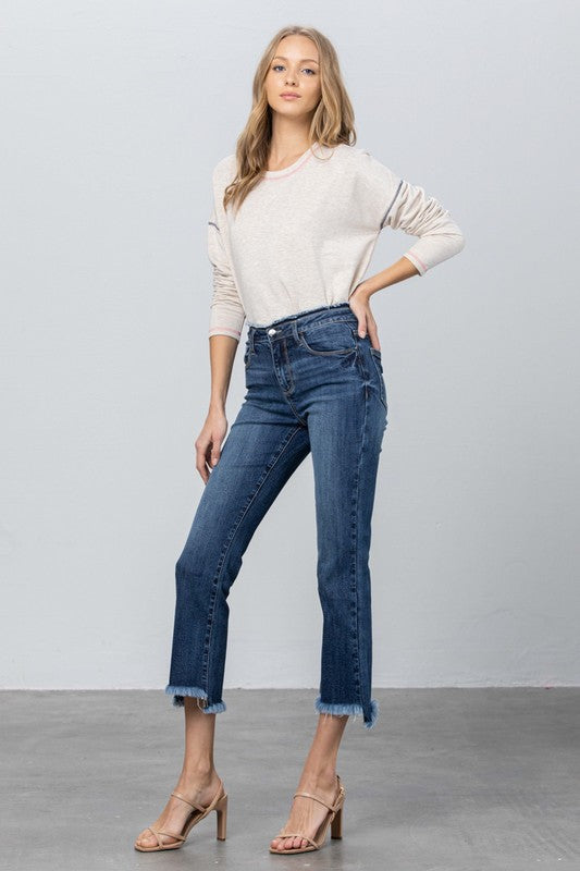 Dark blue slim-bootcut crop jeans with visible seams and frayed ankle hem