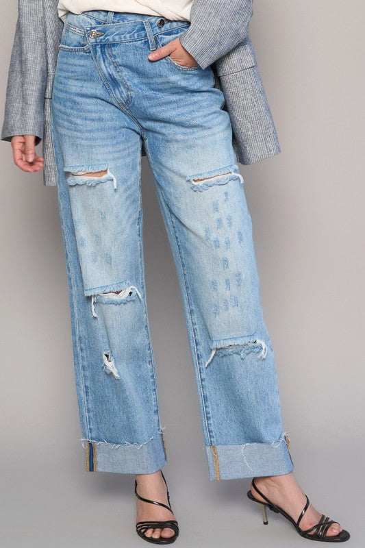Medium wash high-waist ripped straight jeans with large knee rips and distressed patches.