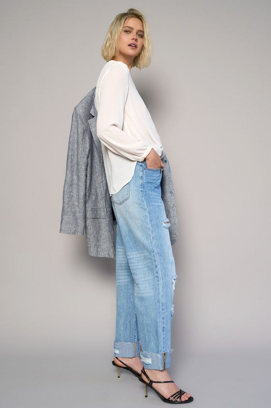 High-waist ripped straight jeans in medium wash with side view and knee-to-hem distressing.