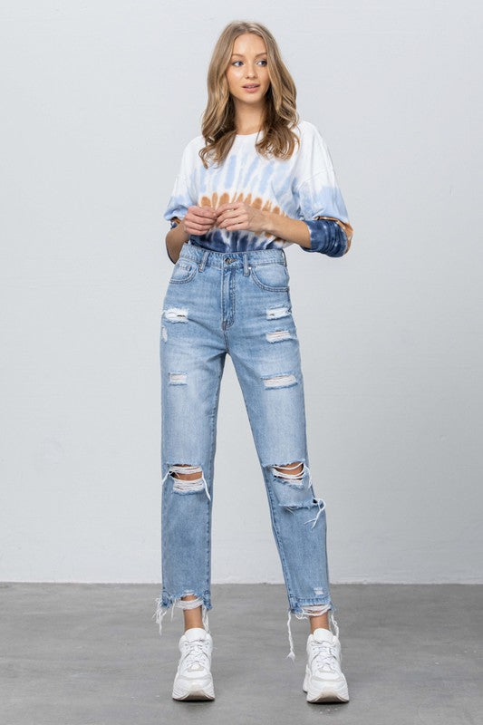 High-waist girlfriend jeans, medium blue wash, distressed knees and raw frayed cuffs