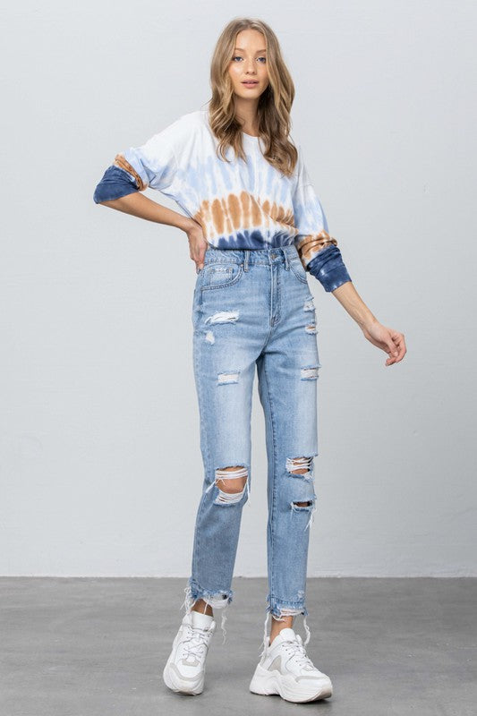 High-waist ripped jeans, medium wash denim with multiple knee rips and frayed hems