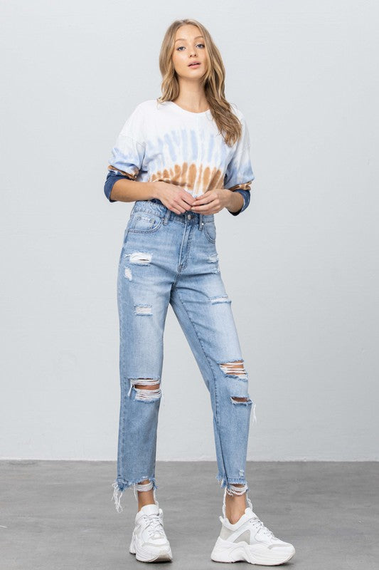 Medium-wash high-rise girlfriend jeans with side distressing and frayed ankle openings