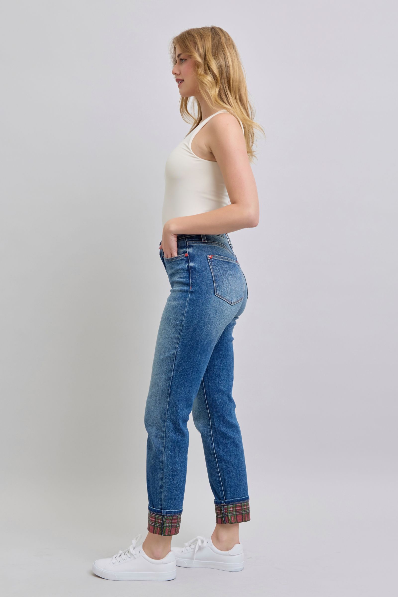Side view straight-leg jeans in medium wash with plaid cuff hem