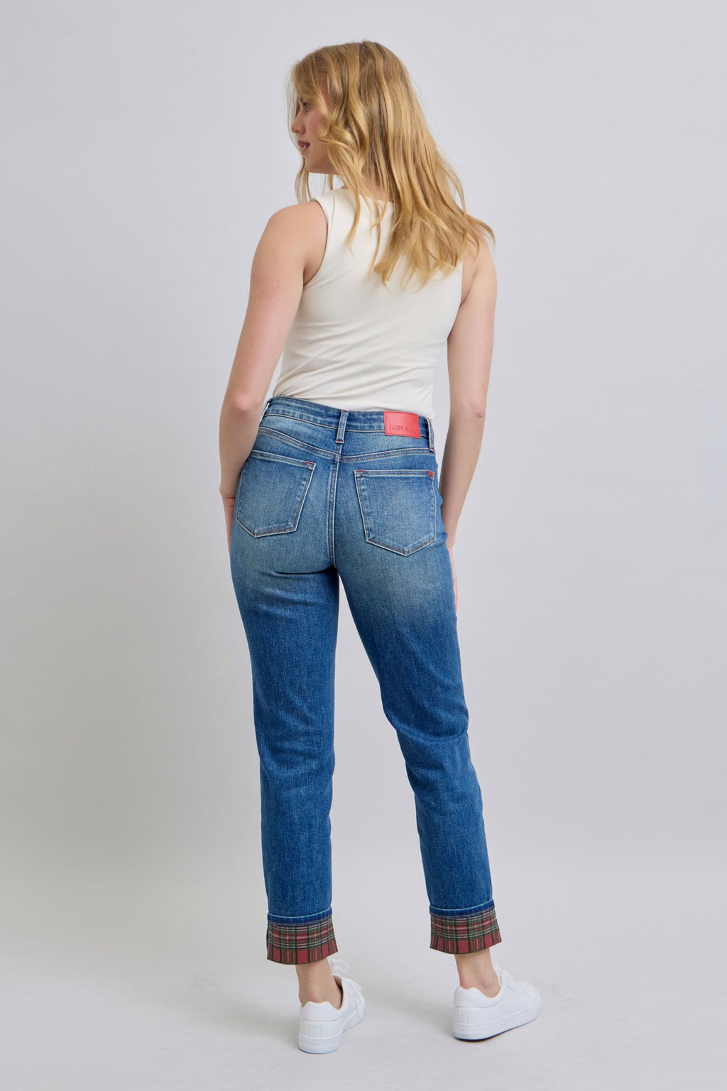 Medium wash straight-leg jeans with plaid cuff hem and dark denim topstitching
