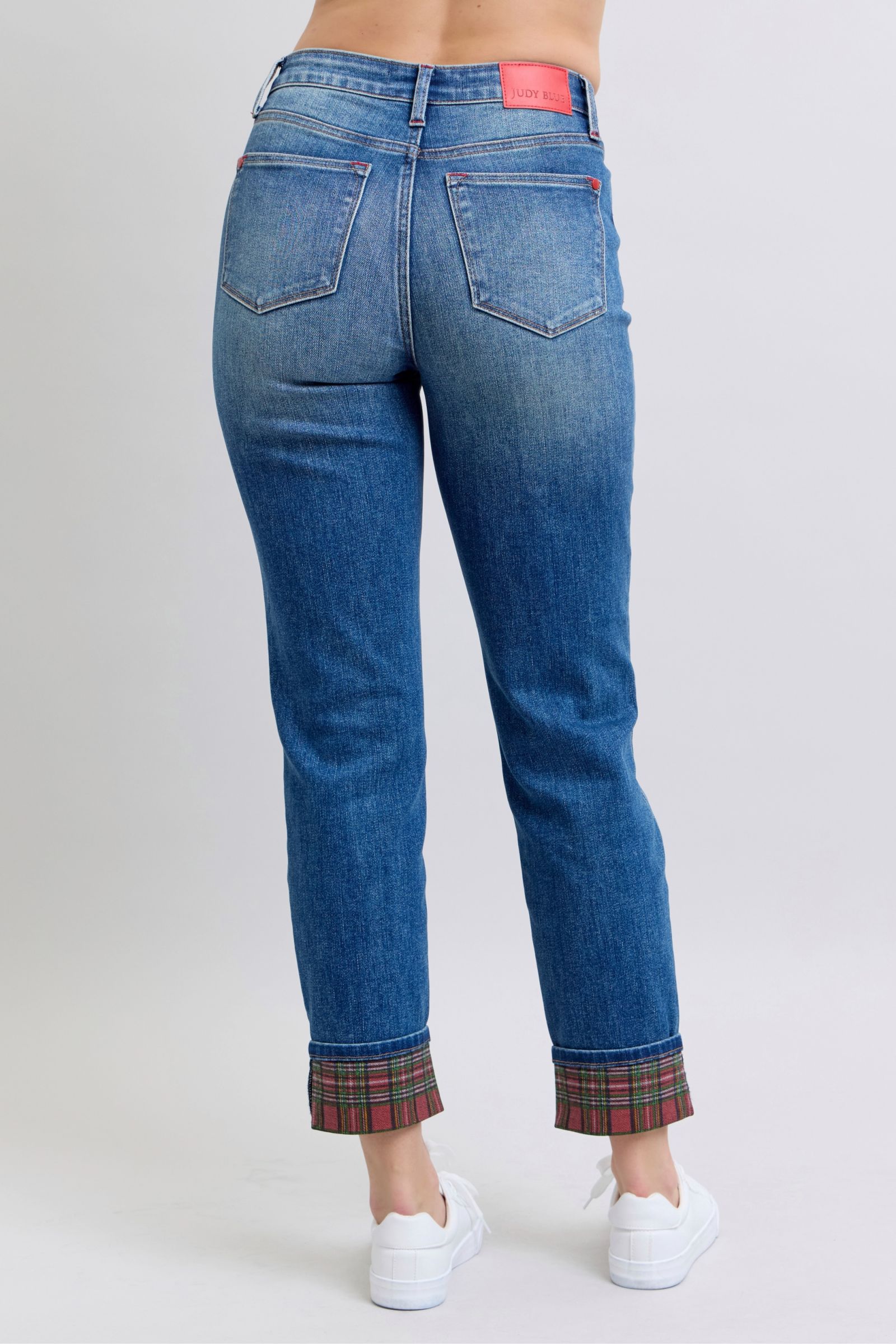 Straight-leg denim jeans with medium wash and plaid cuff hem detail