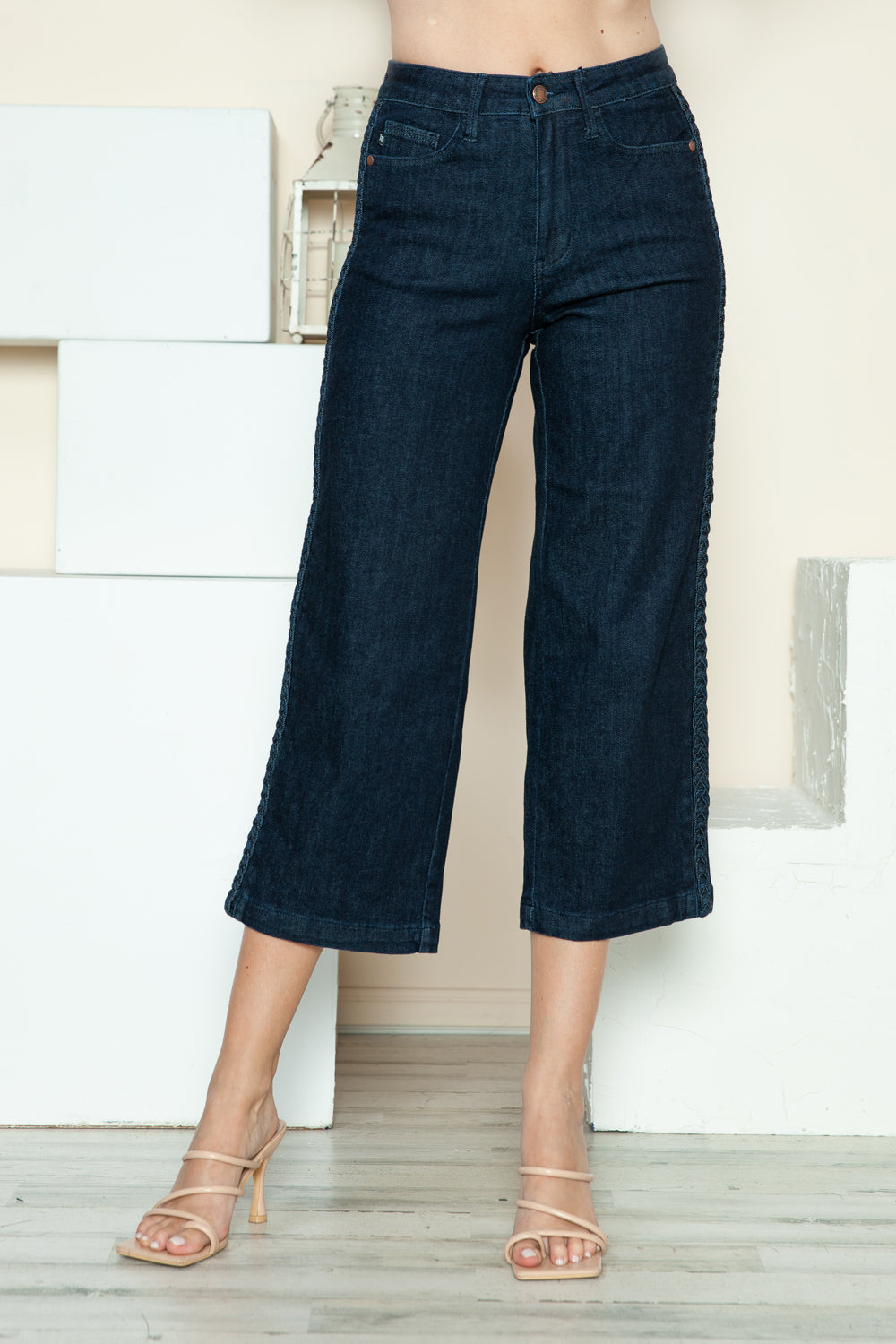 Dark blue wide-leg crop jeans, front close-up showing waistband, belt loops, and pockets