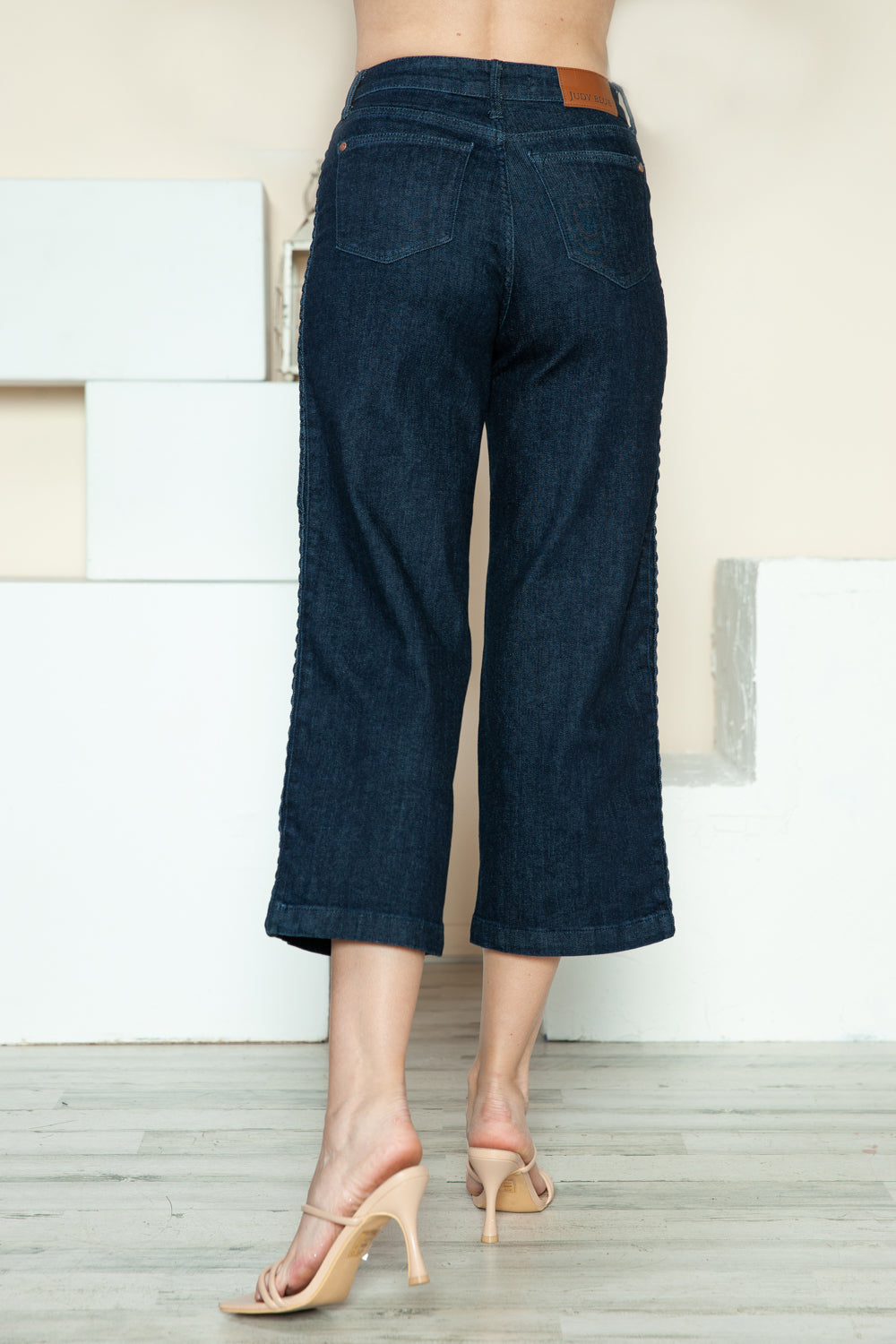 Dark blue crop wide-leg jeans back view with two back pockets and center seam