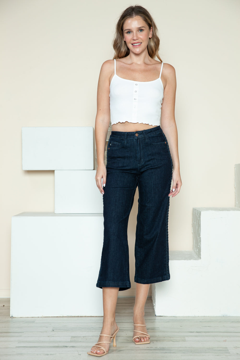 Dark blue crop wide-leg jeans with side braid detail, full front view