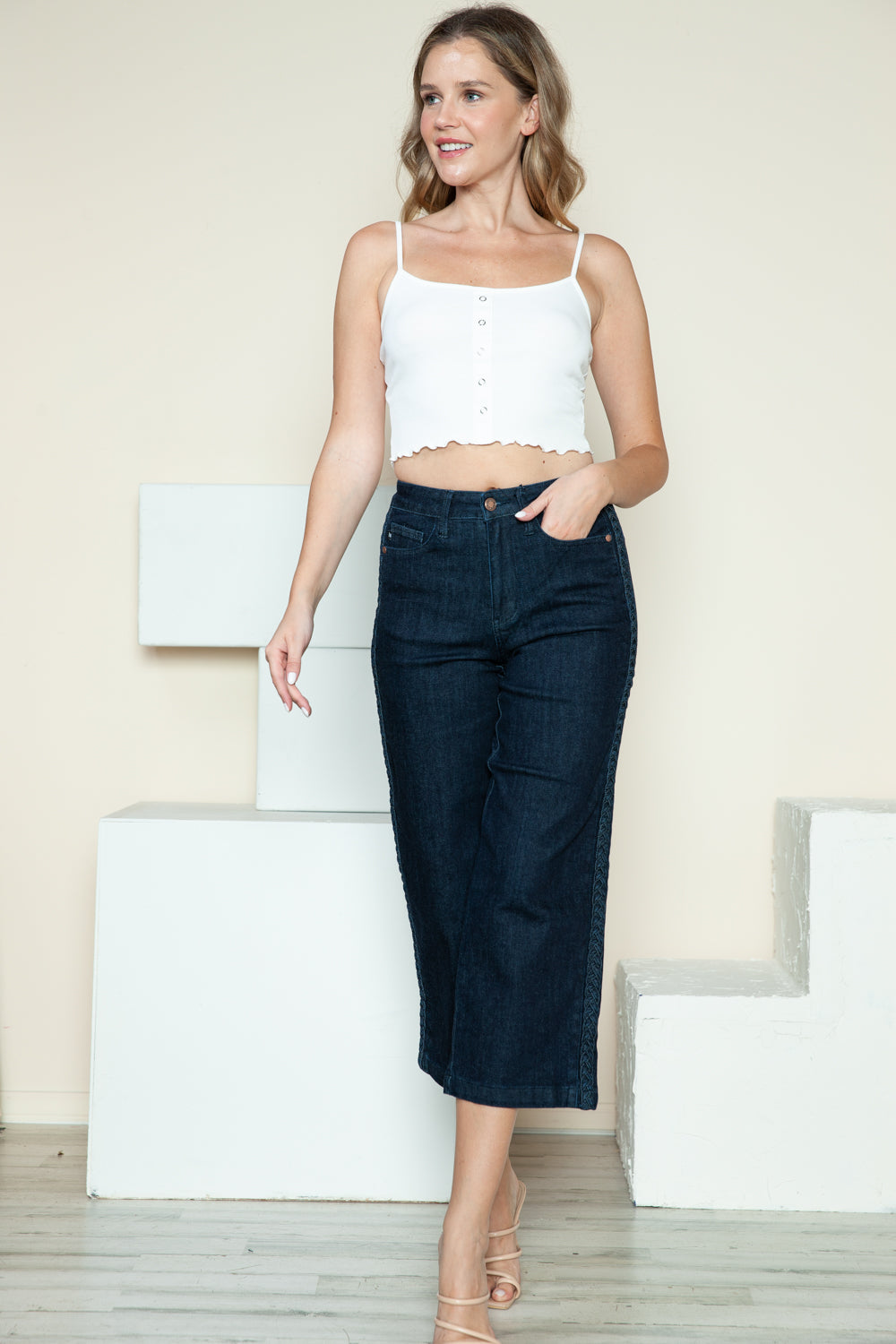 Dark wide-leg crop jeans with side-seam braid detail and button fly