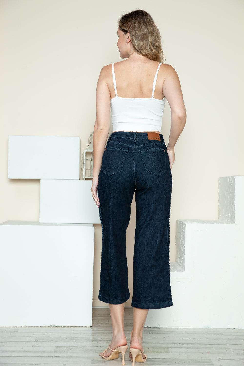 Dark crop wide-leg jeans from back with belt loops and side-seam braid detail