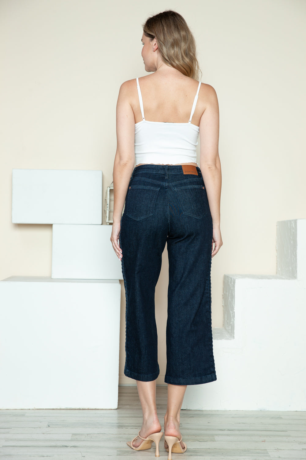 Dark crop wide-leg jeans back view with side-seam braid detail