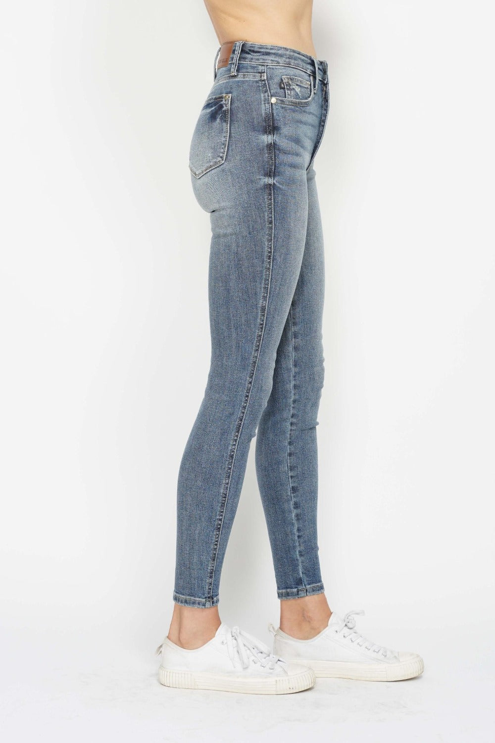 Medium wash skinny jeans, side view with classic five-pocket styling