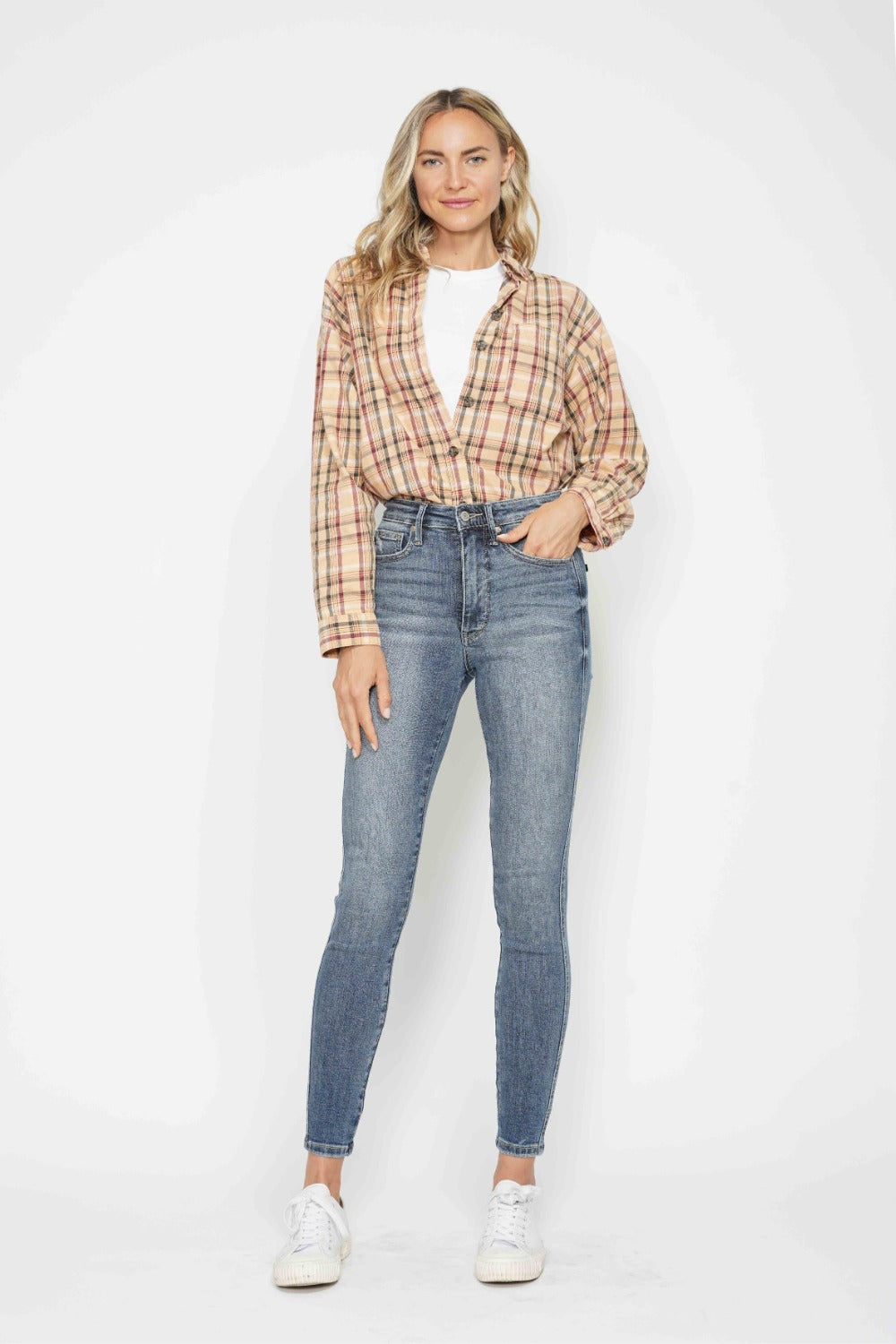 Medium wash skinny jeans with tummy control, front view