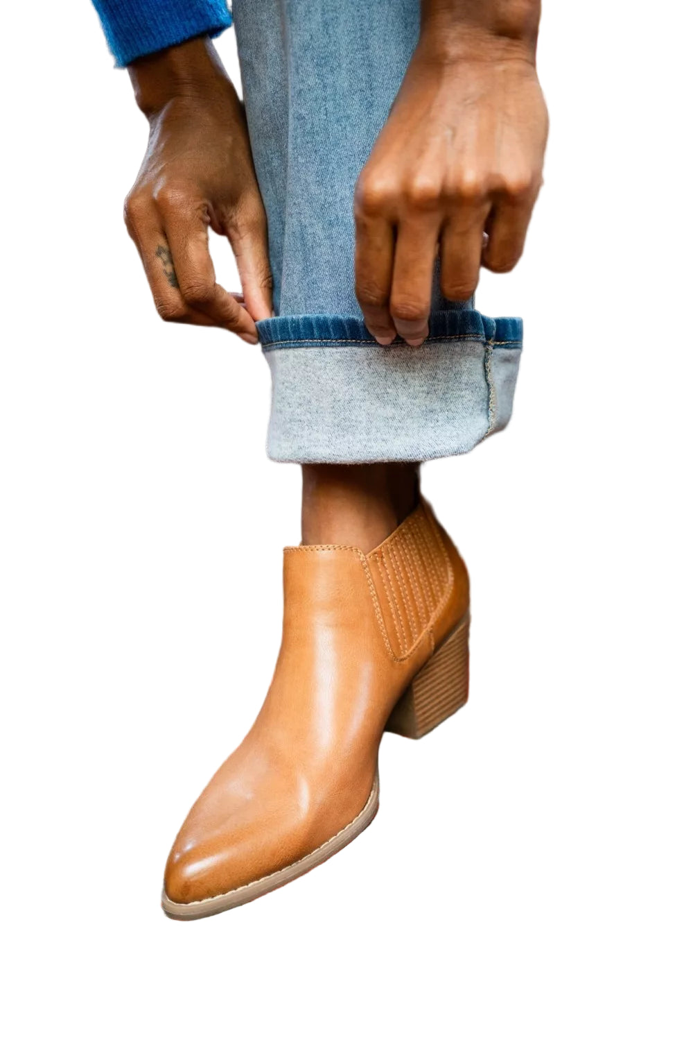 Light blue bootcut jeans with cuff hem detail near brown boots