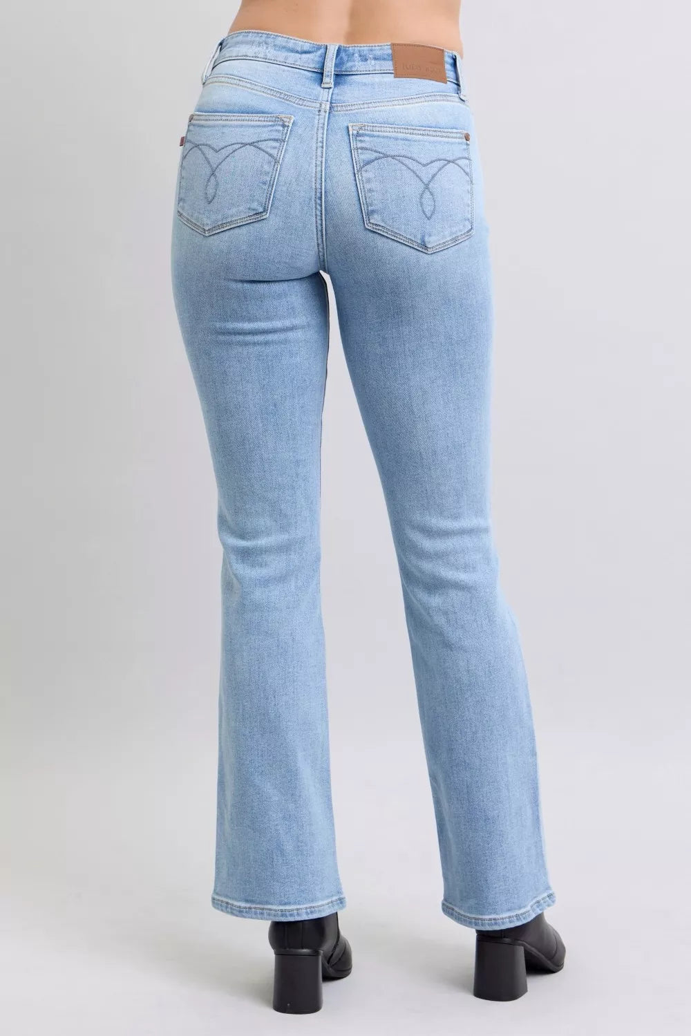 Light blue bootcut jeans with back pockets and yoke seam detail