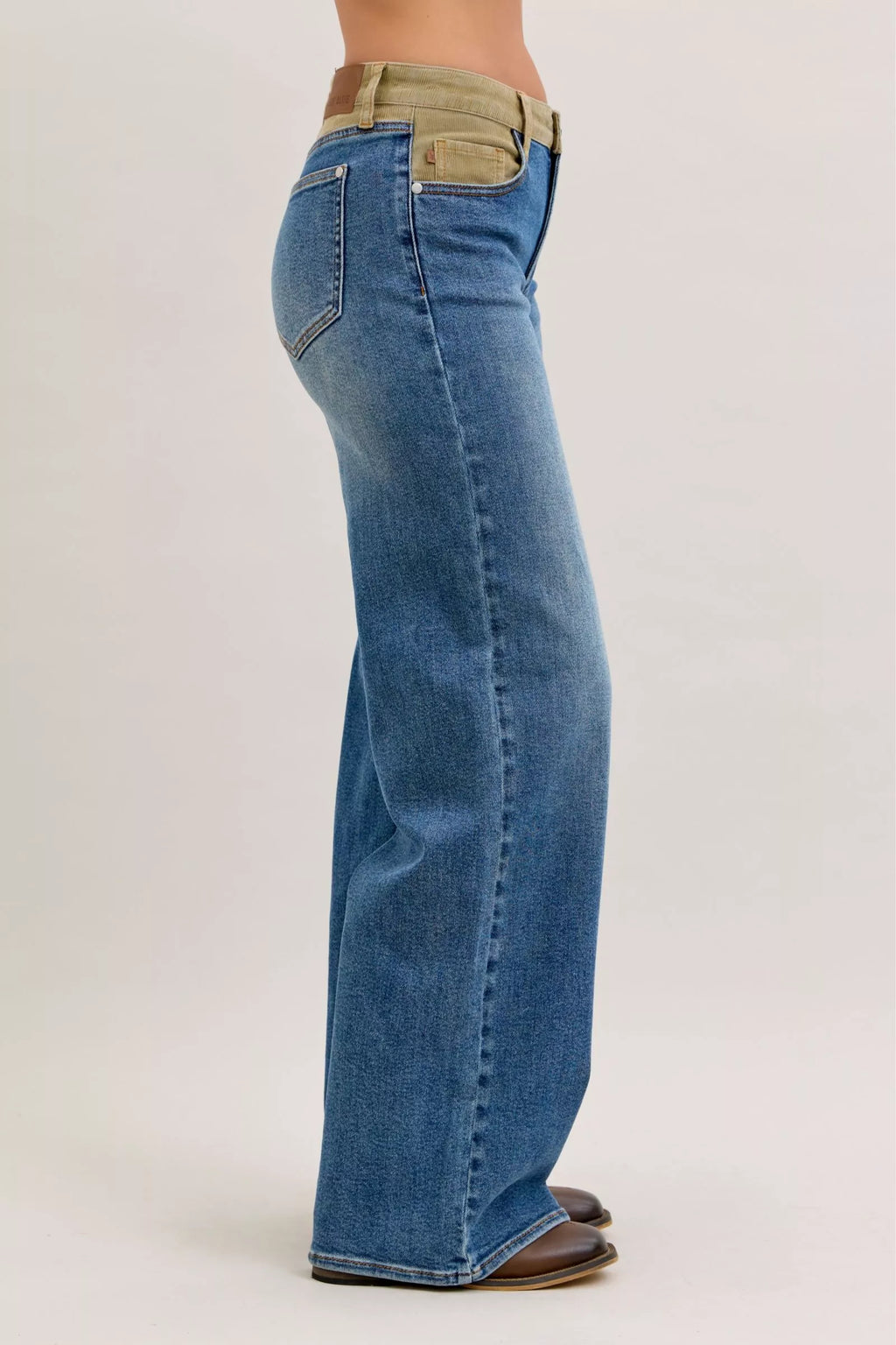 Medium blue straight-leg jeans with corduroy waistband, side view