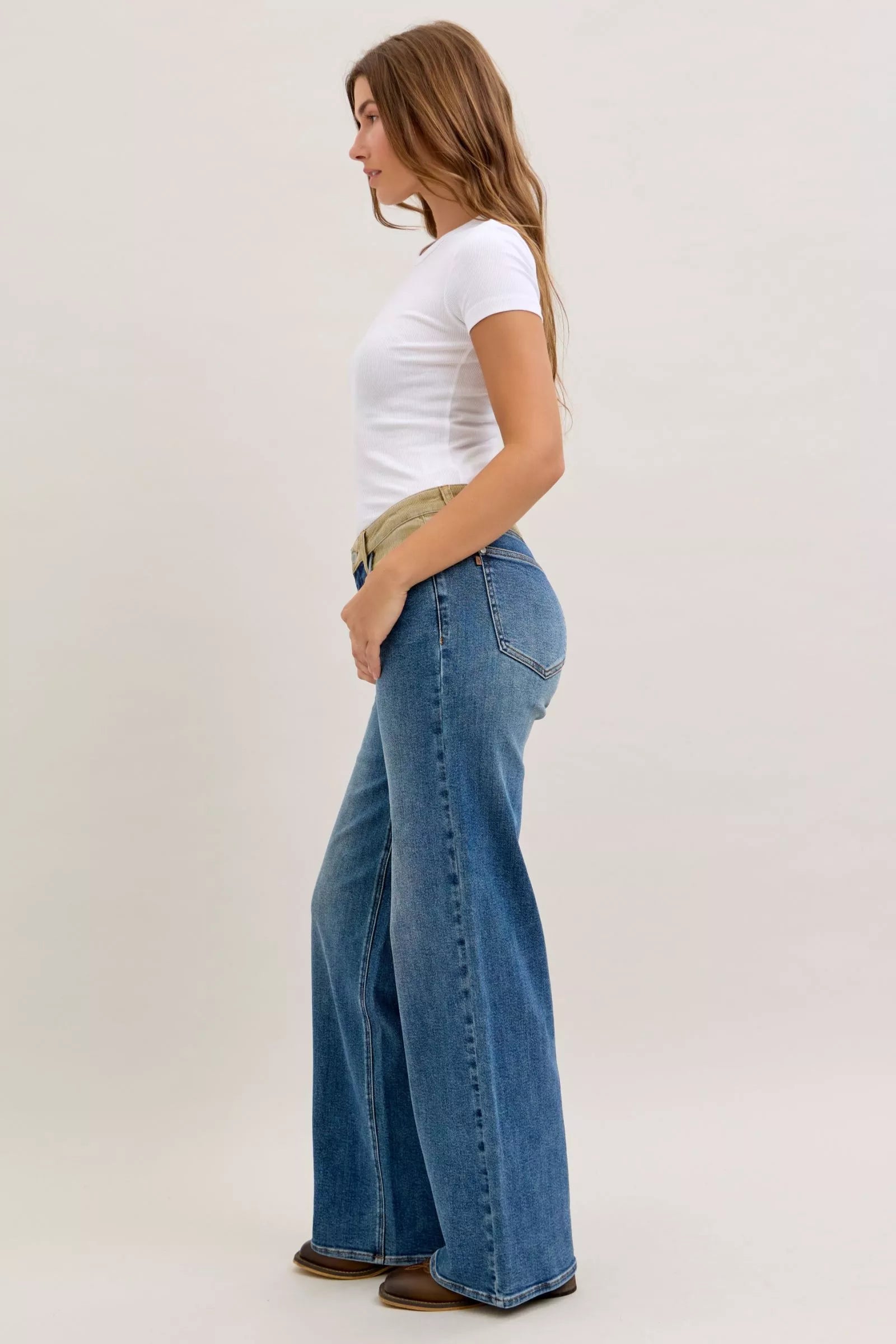 Medium blue straight jeans with corduroy waistband, back three-quarter view