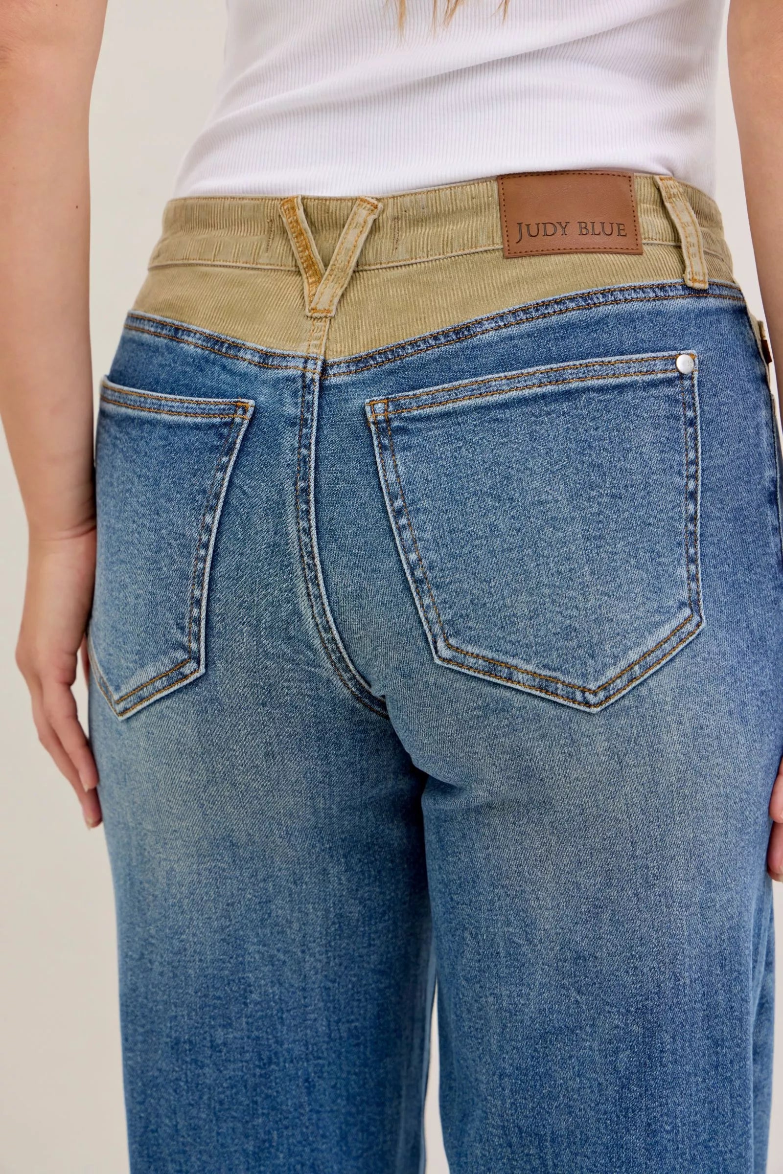 Medium blue Judy Blue jeans, corduroy waistband, back pockets and belt loops close-up