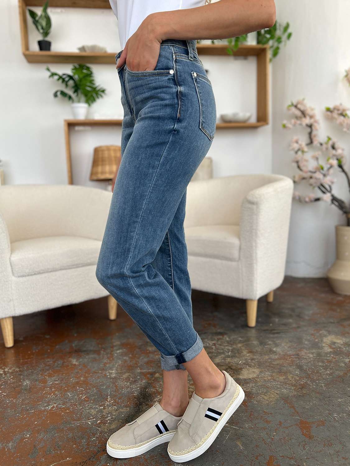 Medium blue slim jeans with side view, cuffed hem, and stitched front pocket