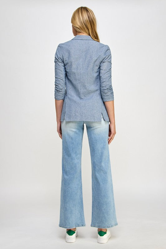 Light blue denim jeans from back view with high-rise fit and relaxed wide-leg silhouette