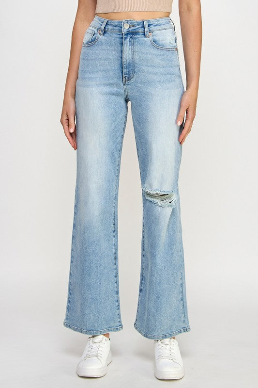Close-up: light blue high-rise relaxed wide-leg jeans with front button and straight wide legs