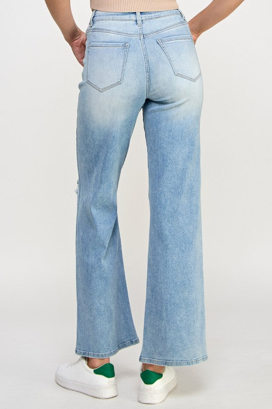 Light blue high-rise relaxed wide-leg jeans, back view with subtle fading and wide leg opening