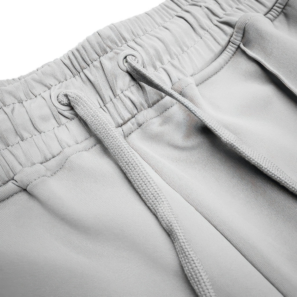 Grey drawstring waist and seam details on stacked flare pants with side stripe