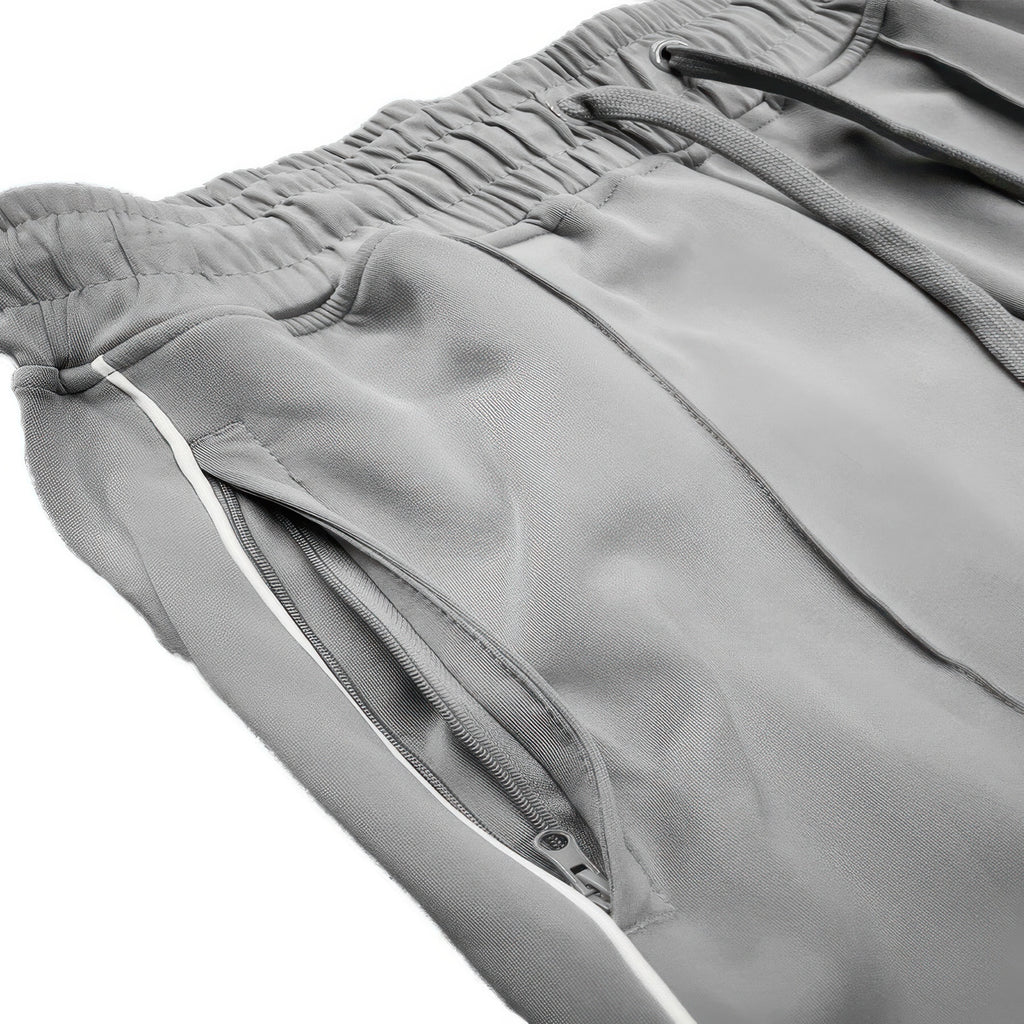 Grey stacked flare pants pocket and seam close-up with white side stripe