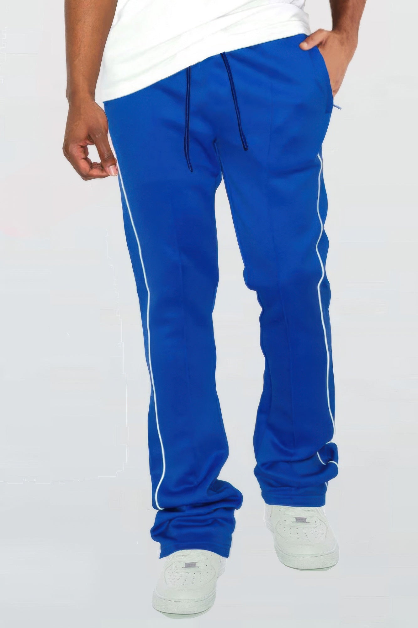 Royal blue stacked flare pants with white side piping and cuffed hem