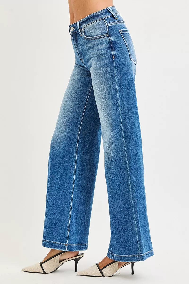 Blue mid-rise wide flared jeans, side view with long flare leg opening