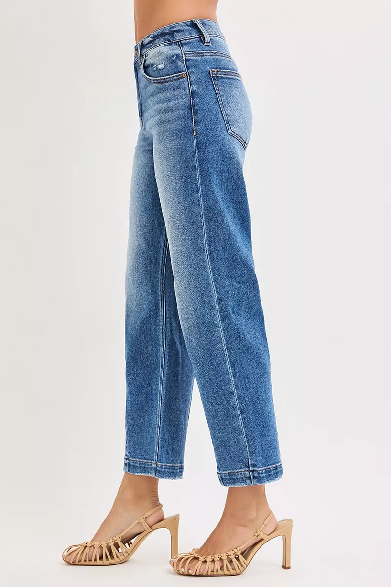 High-rise crop boyfriend jeans, dark blue denim, side view and cropped hem