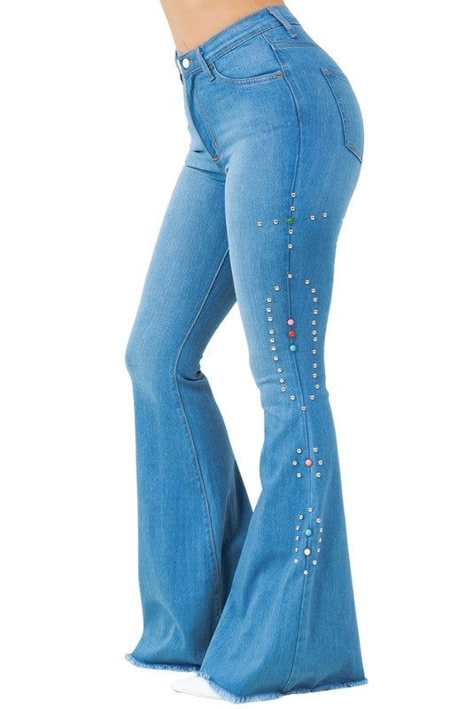 Bell-bottom jeans, side view with stacked rhinestone trim and flared hem.