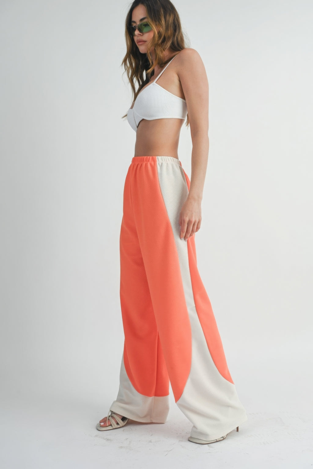 Two-Toned wide-leg pants in coral with light side panels, elastic waistband.