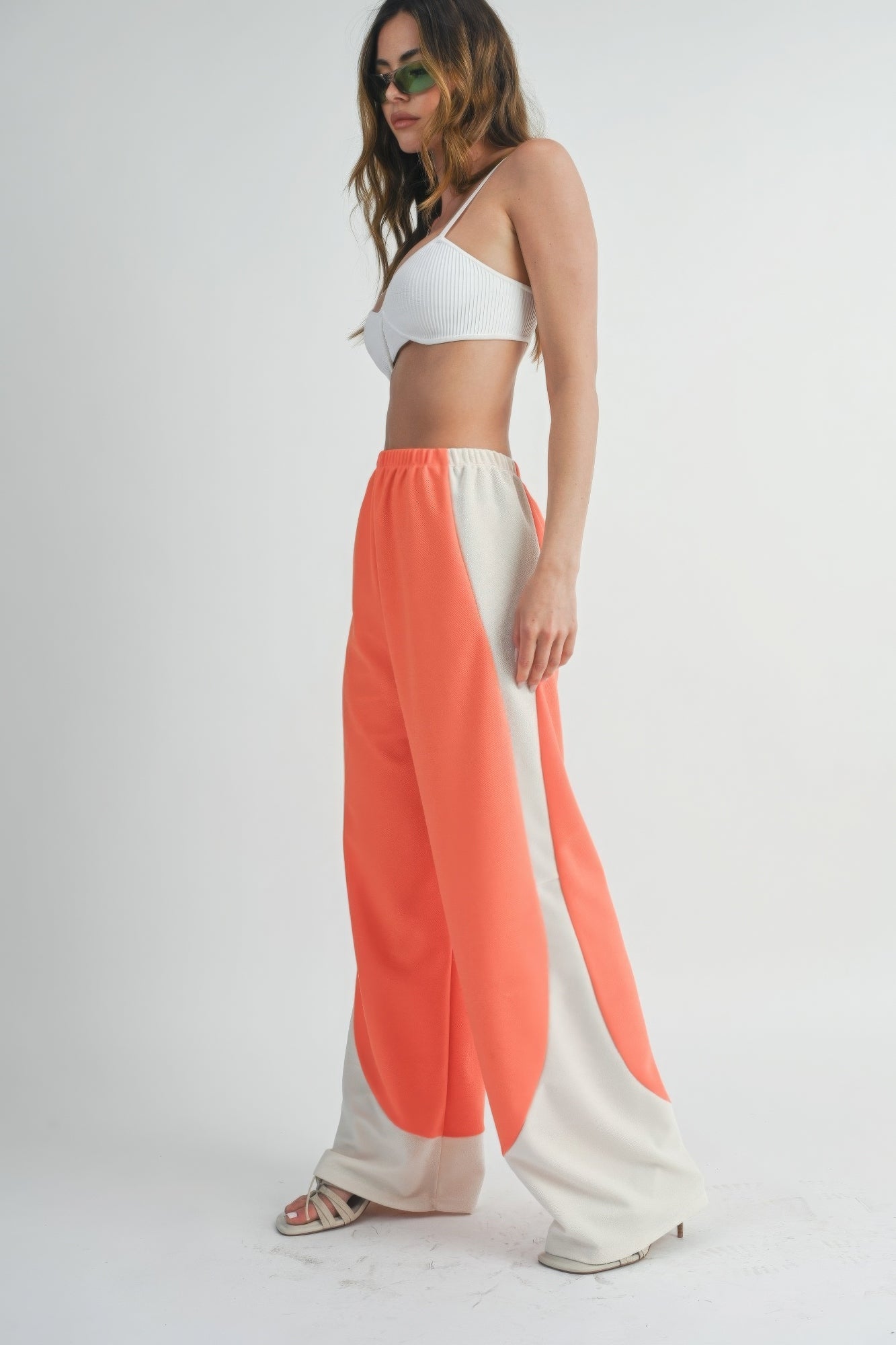 Two-Toned wide-leg pants in coral with light side panels, elastic waistband.