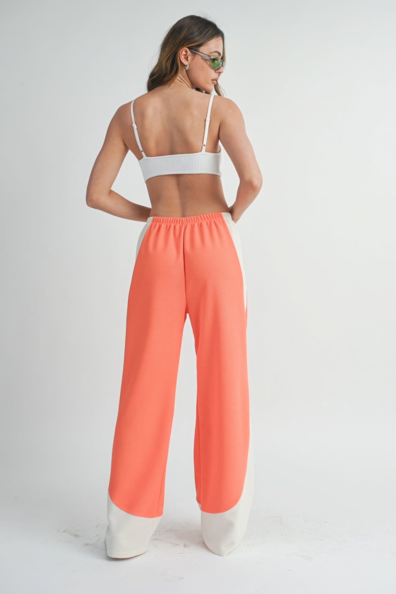 Two-Toned wide-leg pants in coral with light contrast panels at the lower legs, elastic waist.