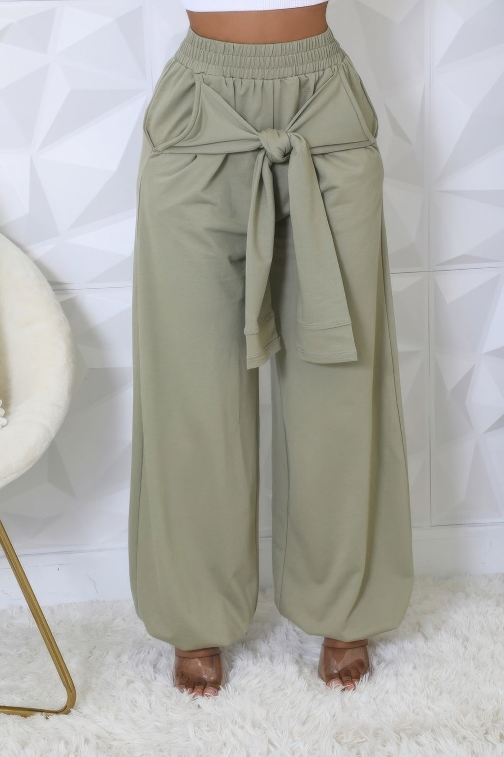 Olive high-waist stretch pants featuring a wide-leg cut and front bow tie