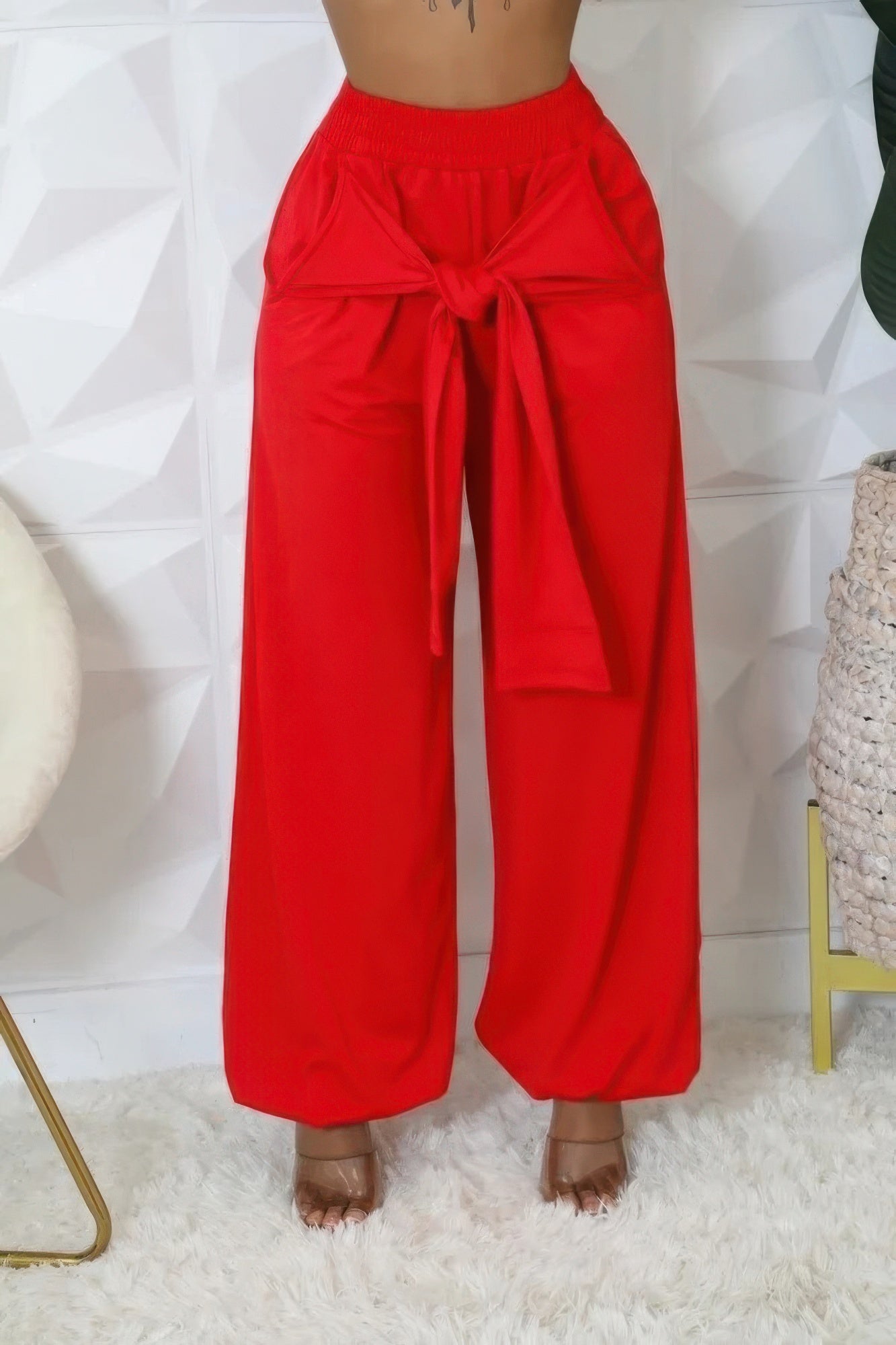 Red high-waist stretch pants with roomy wide legs and front tie at waist