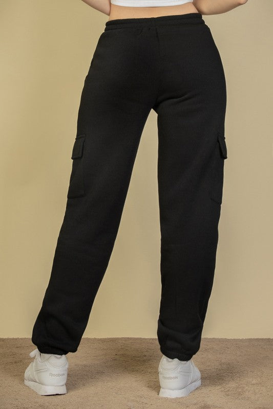 Black sweatpants with side cargo pockets, elastic waistband and relaxed fit