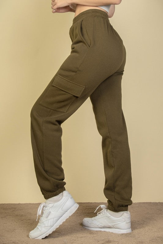 Olive women's sweatpants with side cargo pockets and drawstring waist, tapered cuffs