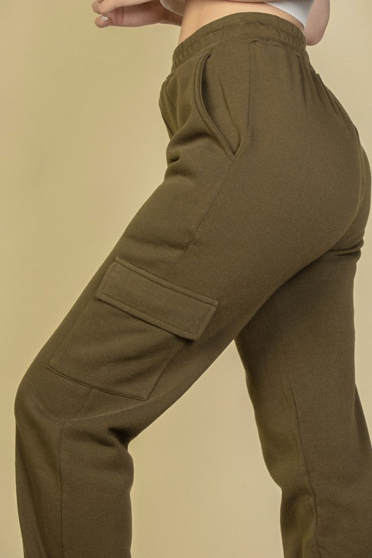 Olive sweatpants close-up: side cargo pocket and drawstring waistband
