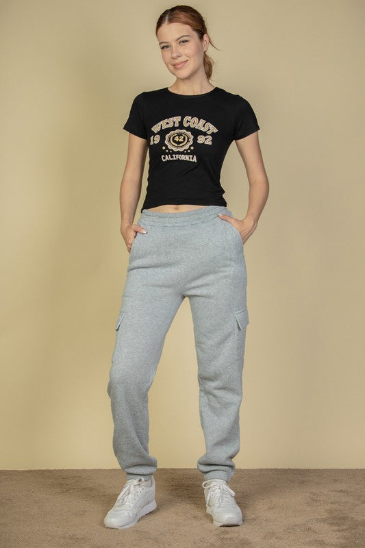 Women’s heather grey drawstring sweatpants with side pockets and cuffed hems