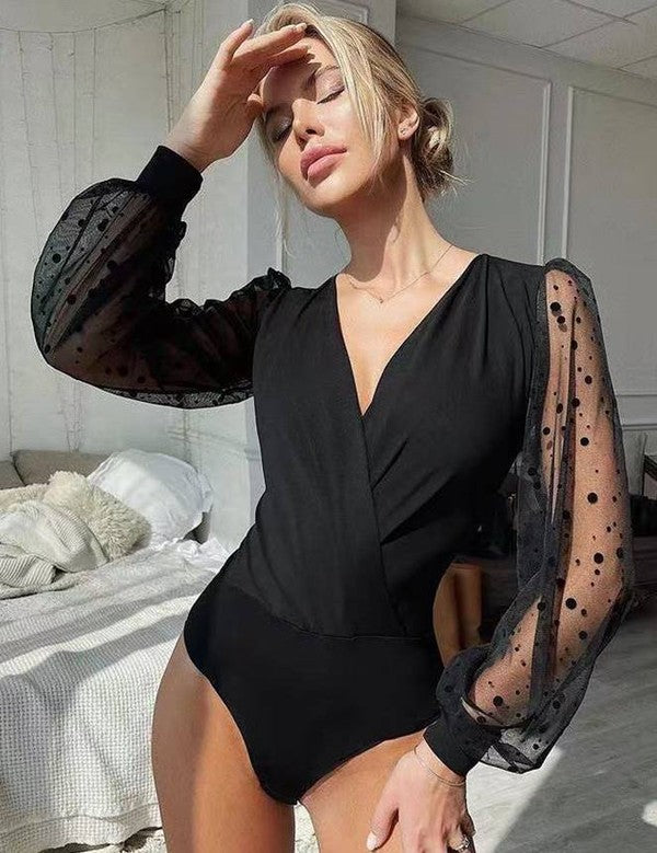 Black polka-dot sheer long-sleeve bodysuit with deep V neckline and fitted waist